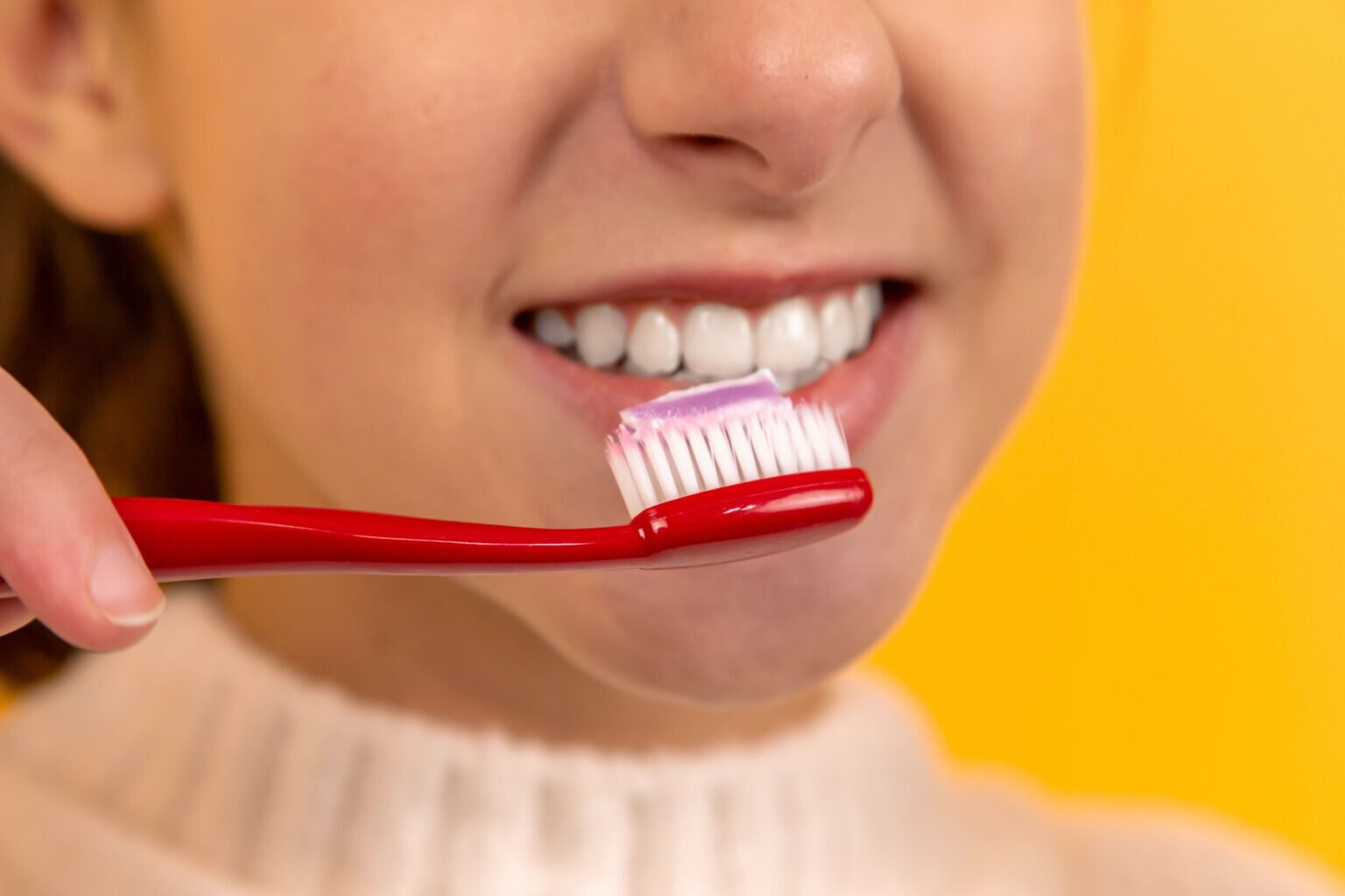 Sherman Oaks cosmetic dentistry patient model brushing her teeth teeth