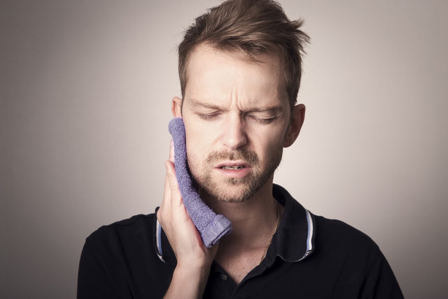 Sherman Oaks bruxism treatment patient model pressing a cloth to his jaw