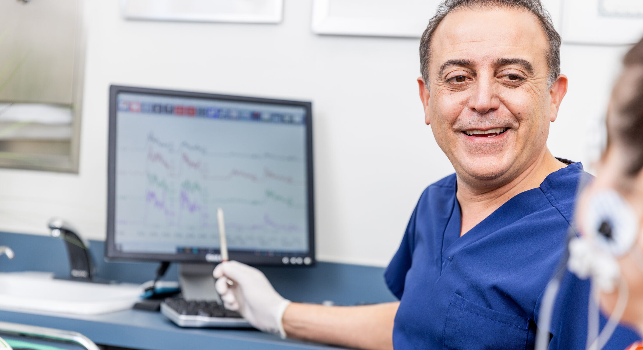 Dr. Eddie Siman consulting with a patient in his office